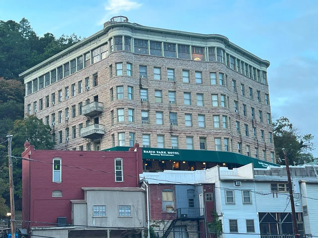 A building with many windows and a green awning.