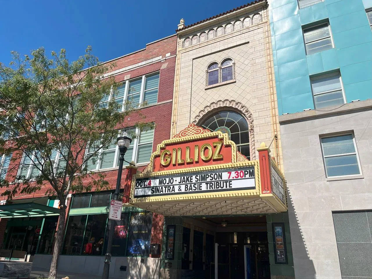 A theater with a large sign on the front of it.