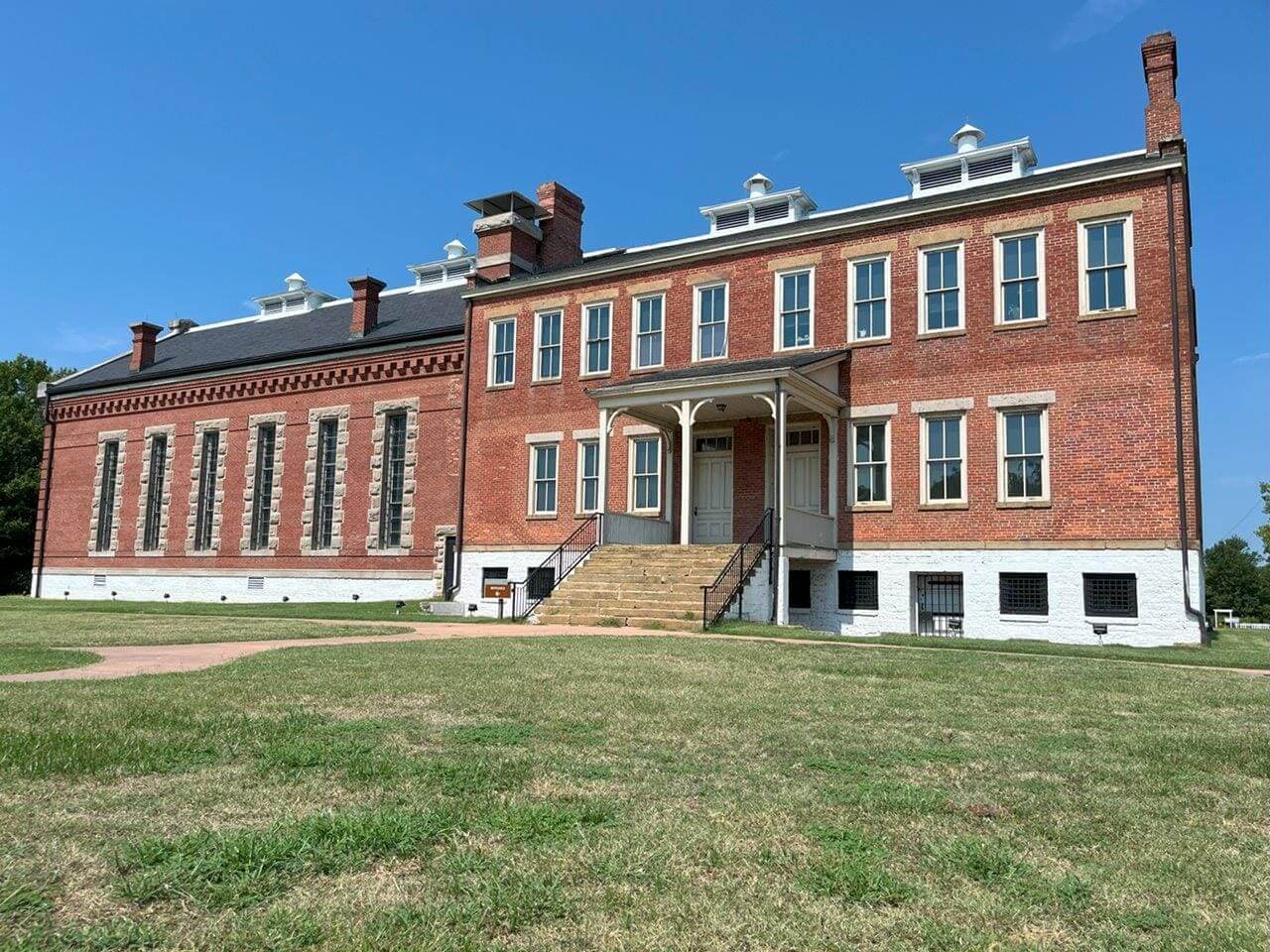 Red brick historic courthouse with central stone steps